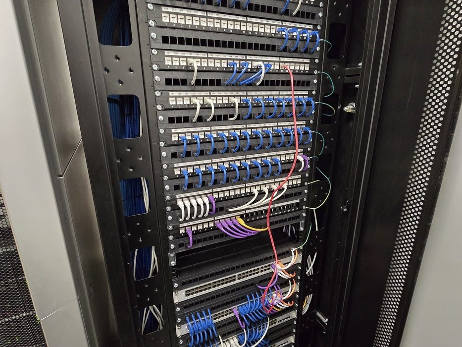 Clean, organised server cabinet with colour-coded patching after Forge42 work