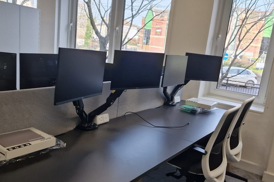 Triple monitor workstation setup completed by Forge42 Tech